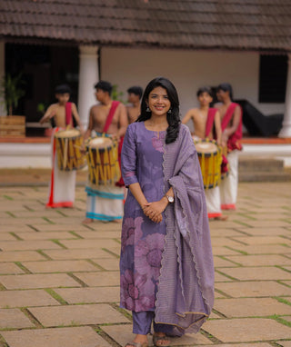 Woman in purple floral kurti set for Onam festival